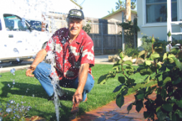 an Aptos Sprinkler Repair tech checks a bad pop up head 