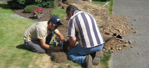 two Santa Cruz Sprinkler Repair members install a new sprinkler extension